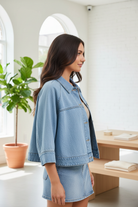 Statement denim cape jacket with flowy silhouette, button-up front, and lightweight cotton construction side view
