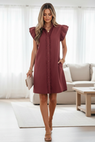 Earthy red denim shift dress with ruffle short sleeves, frill trim, and button-down front