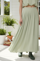 Sage green skirt detail - pleated front on porch