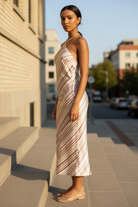 Elegant satin halter dress with open back and diagonal stripe print in grey berry tones