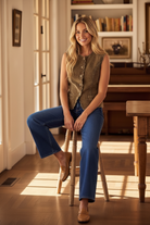 Olive green corduroy vest with feminine scallop detail and soft cotton feel