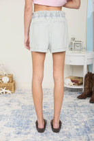 Back view of the lightweight pinstripe denim shorts showing the flattering high-rise fit.