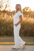 Side view of grey wide leg pants and half zip polo set with relaxed fit