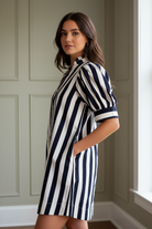 Relaxed striped mini dress for women featuring puff sleeves, ruffle trim and 100% cotton fabric from Thread Bar Boutique