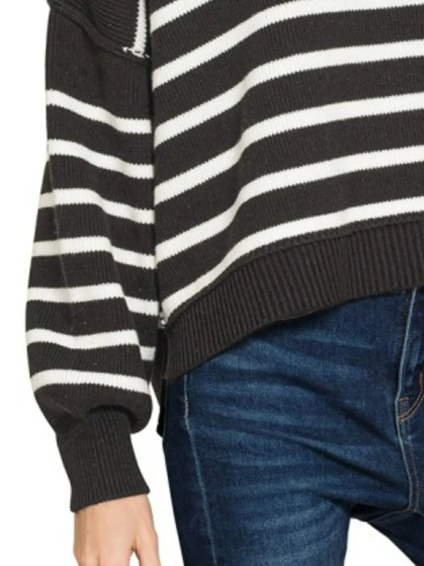 Close-up detail of Zenana Striped Sweater showing exposed seam along sleeve, ribbed cuff, and ribbed hem in black and white stripe kn