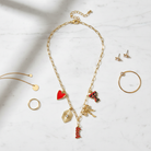 Texas Tech Red Raiders Paper Clip Charm Necklace - flat lay on white marble with gold accents
