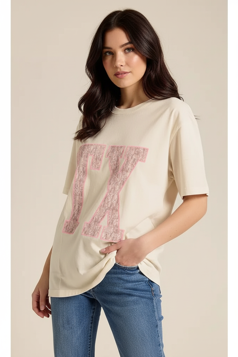 Texas pride TX graphic t-shirt from Thread Bar Boutique with pink puff print lettering, oversized boyfriend fit, and vintage cream mineral wash fabric.