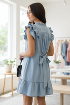  Umgee light denim ruffled babydoll dress with belt tied in back showing ruffle details