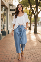 Risen medium wash slouchy crop barrel pleated jeans. Slight stretch, sizes 0–15, tailored pleated detail. Modern vintage denim at Thread Bar Boutique.