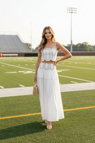 Women's white game day skirt set featuring a fitted lace trim top and flowing skirt, creating a feminine two-piece outfit for football games, tailgates, brunch, and events.