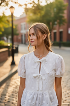Thread Bar Boutique women’s white eyelet top with short sleeves and breathable 100% cotton fabric for warm weather styling.