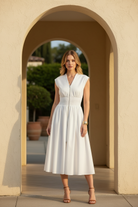 white zip front smocked waist midi dress standing in sunlit villa doorway, full body front-facing shot, tan strappy heeled sandals, elevated boutique lifestyle photo