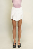 Butter soft faux leather tulip skort with bow tie detail and built-in shorts for women from Thread Bar Boutique