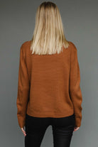 Camel knit sweater with “Whiskey Weather” black lettering, relaxed cozy fit.