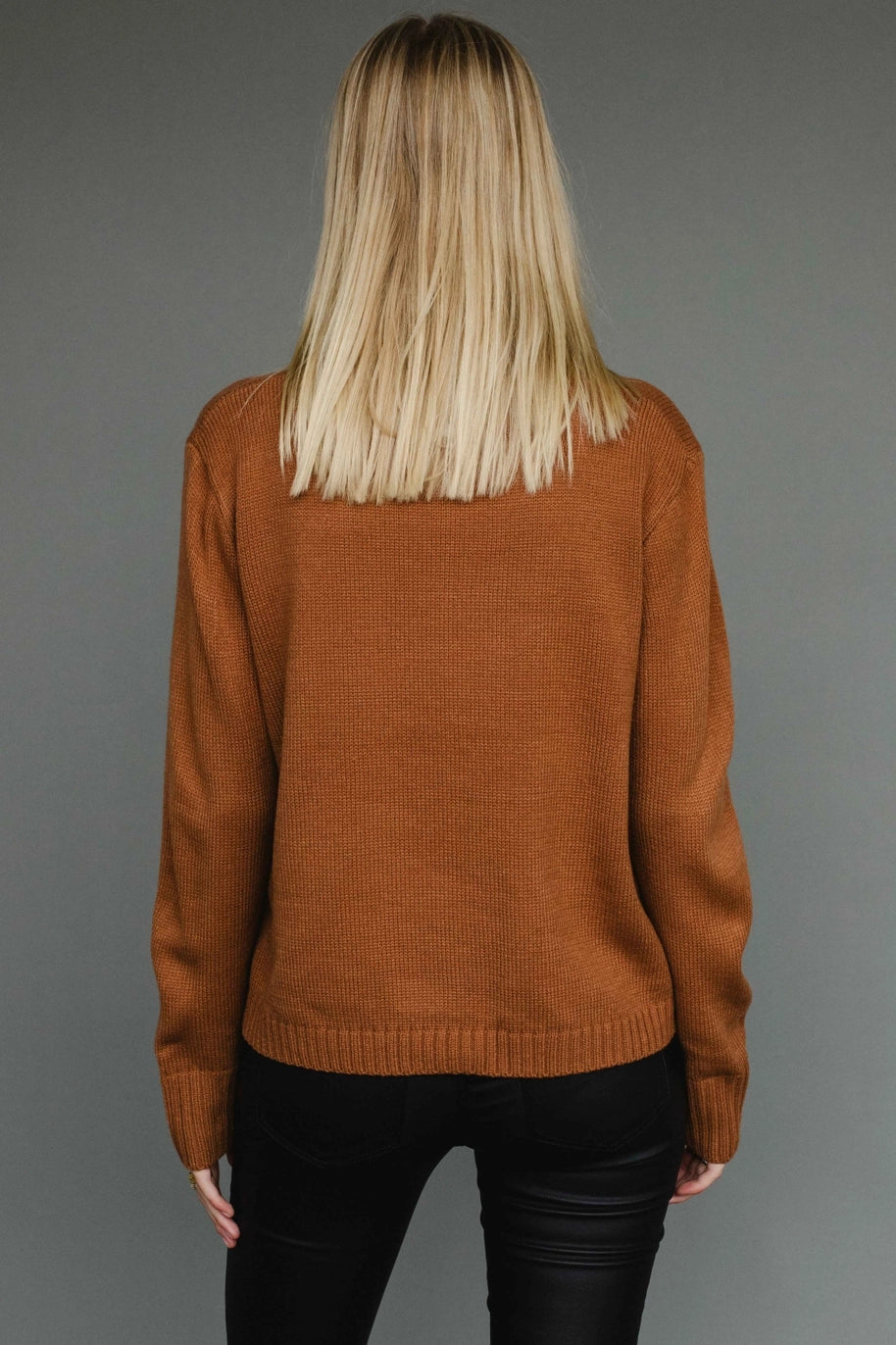 Camel knit sweater with “Whiskey Weather” black lettering, relaxed cozy fit.