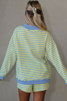 yellow and blue striped mock neck pullover and shorts matching set for women, trendy stripe two piece lounge outfit with color block trim, women’s striped matching set featuring mock neck top and loose fit shorts, casual boutique striped outfit set
