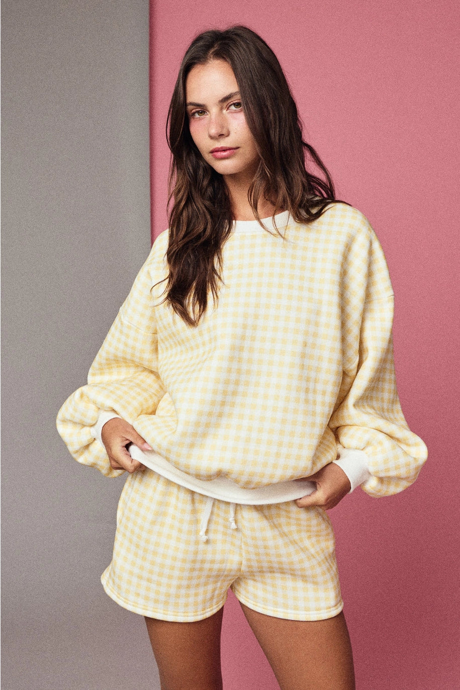 Yellow and white gingham cozy chic women’s lounge set featuring a plush crewneck sweatshirt and drawstring shorts with pockets