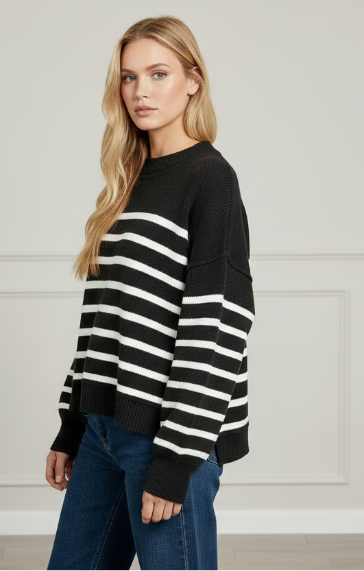 Upper body crop of Zenana Exposed Seam Striped Oversized Sweater — crew neckline, black and white stripe pattern, drop-shoulder silhouette